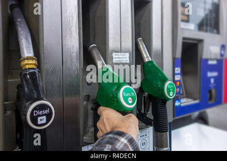 Mann Auswahl Benzin Kraftstoff Pumpe Düse an der Tankstelle tanken sein Auto in Europa Stockfoto