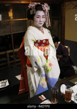 Eine 16 Jahre alte Maiko (Azubi Geisha) in voller Tracht, in der Gastfreundschaft und Unterhaltung Industrie in modernen Kyoto, Japan arbeiten Stockfoto