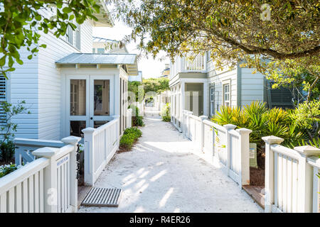 Seaside, USA - 25. April 2018: White Beach Holz Holz Architektur, Weg mit grünen Landschaftsgestaltung Sträucher, Büsche Bürgersteig für den Ruhestand oder vacatio Stockfoto