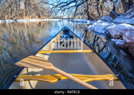 Ansicht von einem Kanu paddeln auf einem Fluss im Winter Landschaft Stockfoto