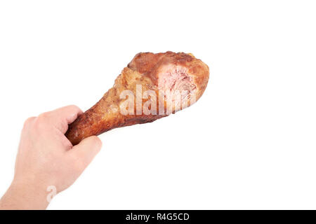 Hand, die Hähnchen Bein mit Biss, auf weißem Hintergrund. Stockfoto