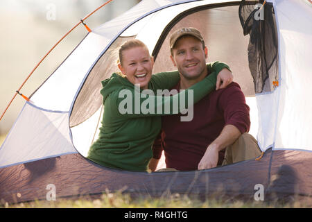 Glückliches junges Paar in einem Zelt sitzen zusammen Stockfoto