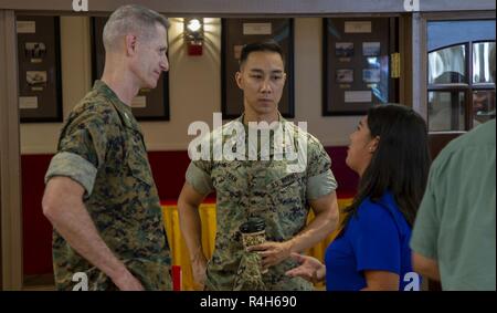 Marines der Erfolg der Taktischen & Tech Tag mit Kristen Coker diskutieren, Event Manager mit nationalen Konferenz Dienstleistungen, am Desert View Club, an Bord der Marine Corps Air Ground Combat Center, Twentynine Palms, Calif., Okt. 2, 2018. Die taktische & Tech Tag gibt Verteidigungsministerium Auftragnehmern die Möglichkeit, Unit Leader ist das Zentrum der neuesten verfügbaren Technologie zu zeigen. Stockfoto