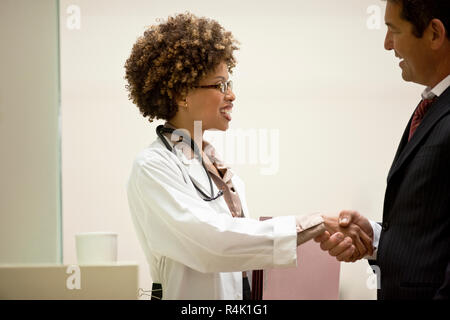 Ärztin Händeschütteln mit einem Kollegen. Stockfoto