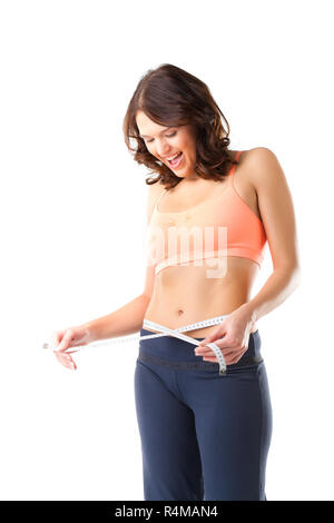 Diät - junge Frau ist das Messen ihrer Taille Stockfoto
