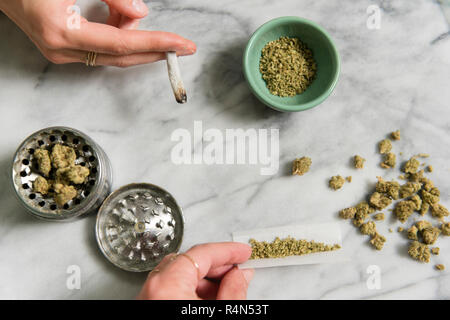 Die Hände der Frauen zu rollen, und das Rauchen von Marihuana Gelenke Stockfoto