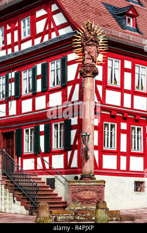 Historische Fachwerkhaus mit Mariensäule auf dem Marktplatz in Amorbach Stockfoto