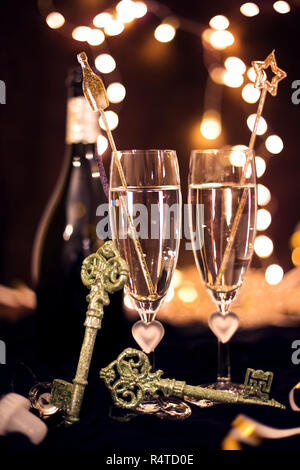 Andrzejki, sylwester von Toast für Zwei. Champagner und Wahrsagerei auf schwarzem Hintergrund. Feier, Lichter und neues Jahr Stockfoto