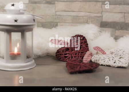 Winter Zusammensetzung mit gemütlichen Kissen, Laterne und Herzen verziert. Winterurlaub Konzept. Stockfoto