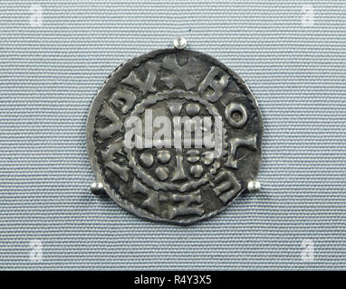 Die älteste Tschechische Münze aus dem 10. Jahrhundert datiert auf Anzeige an der Ausstellung im Nationalmuseum (Národní Muzeum) in Prag, Tschechische Republik. Die mittelalterlichen böhmischen Silber münze (denar) in Prag unter der Herrschaft des Herzogs Boleslaw ich die Grausame minted vor 966 gilt als die älteste erhaltene Münze zu sein, im Gebiet, das heute das Tschechische Republik geprägt. Ein Kreuz mit neun dotes ist in die Münze mit einer Inschrift um 'BOLEZLAV DVX' ('Duke Boleslaw") dargestellt. Die Ausstellung zum 200. Jahrestag des Nationalen Museum präsentiert 200 der wichtigsten Elemente aus Stockfoto