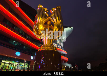 Nacht Blick auf die Forever Blooming Bauhinia Skulptur mit Hong Kong Convention & Exhibition Centre im Hintergrund, Hong Kong Wan Chai Stockfoto