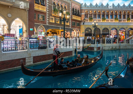 Touristen Reiten auf der Gondel entlang der künstliche Kanal der Venetian Macau, das größte Casino der Welt und luxuriösen Hotel. Macau, Januar 2018 Stockfoto