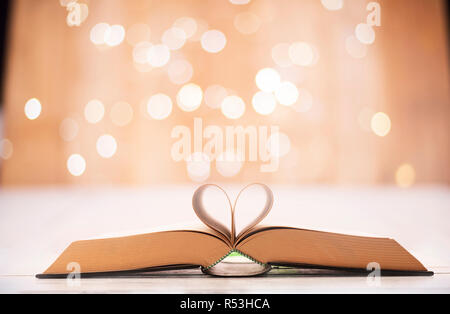 Valentinstag oder lesen Konzept mit herzförmigen Buch auf bokeh Hintergrund Stockfoto