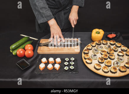 Zutaten für Meeresfrüchte Teller. Küchenchef Schneiden von Gemüse und Fisch Stockfoto