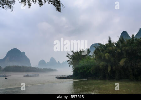 Passagier boads im Nebel über den Fluss in der Nähe von Xingping Stockfoto