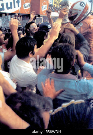 Monza, Autodromo Nazionale, 7. September 1975. XLVI italienischen Grand Prix. Scuderia Ferrari und italienische Fans feiern die Schweizer Fahrers Clay Regazzoni (oben rechts) am Ende seiner siegreichen Rennen. Stockfoto