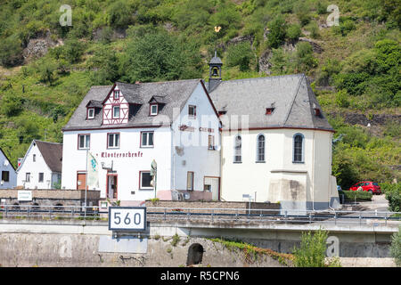 Rhein, Deutschland. St. Sebastian Katholische Kirche, Eingang durch ein Pub (Gasthaus), in der Nähe von wellmich. Stockfoto