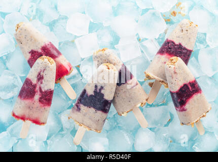 Eis am Stiel mit Früchten, Müsli und Chia Samen. Ansicht von oben Stockfoto