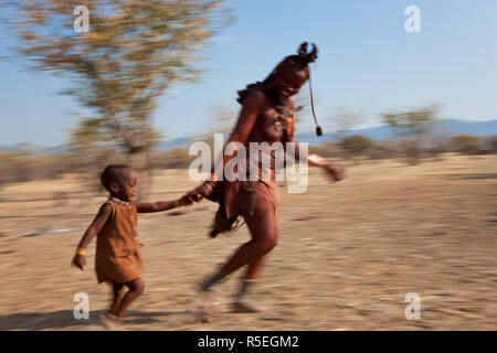 Himba Frau & Kind laufen, Kaokoland, Namibia Stockfoto