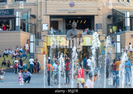 Johannesburg, Südafrika, 1. Dezember 2018. Kinder spielen in den Brunnen in der Nähe der Statue in Nelson Mandela Nelson Mandela Square in Sandton. Südafrika ist derzeit die Feier des 100. Jahrestages der Madiba Geburt. Credit: Eva-Lotta Jansson/Alamy leben Nachrichten Stockfoto