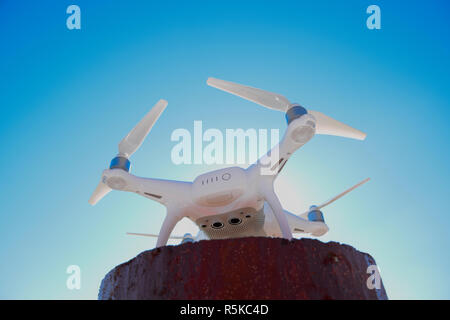 Quadrocopter Phantom 4 gegen den blauen Himmel in der Sonne. Hintergrundbeleuchtung. Dron ist ein innovatives fliegenden Roboter. Stockfoto