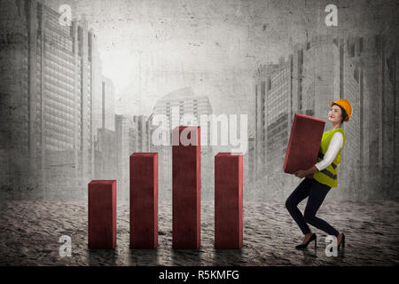 Asian Business woman Lifting Block Diagramm Stockfoto