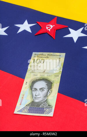 Venezuela Fahne mit Hammer und Sichel, + wertlos Bolivar Fuerte ('starke') Banknote - für Hyperinflation in Venezuela Wirtschaft. Siehe ADDIT. Hinweise Stockfoto