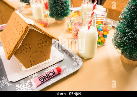 Kinder Partei kleine Lebkuchenhäuser mit Bonbons zu verzieren. Stockfoto