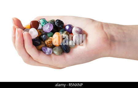 Handvoll mit verschiedenen Edelsteinen isoliert Stockfoto