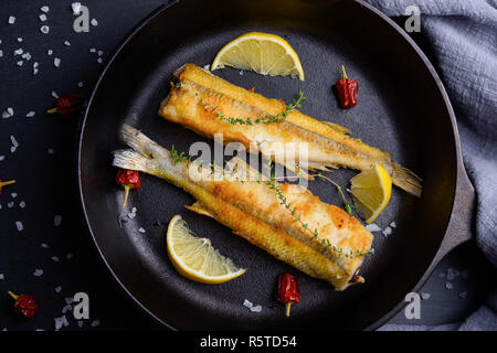 Blick von oben auf die beiden bleischmelzens Fische auf der Pfanne mit Zitrone Stockfoto