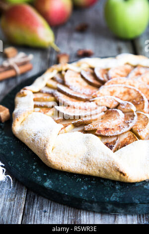 Kuchen mit Äpfeln, Birnen und Zimt auf einem alten hölzernen Hintergrund Stockfoto
