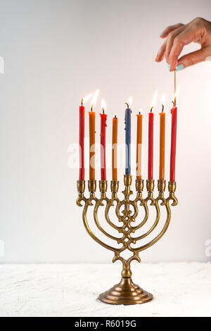 Fragment von Hanukkah und eine Schale mit Olivenöl auf einem weißen Tisch Stockfoto