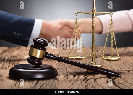 Nahaufnahme einer Hammer und Skalierung auf hölzernen Schreibtisch Stockfoto