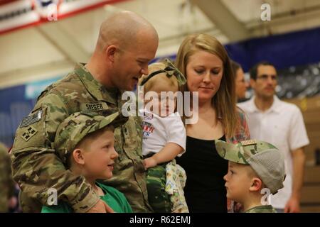 Staff Sgt. Nikolaus Sweger, 704Th Brigade Support Battalion, 2nd Infantry Brigade Combat Team, 4 Infanterie Division, ist mit seiner Familie nach einem homecoming Zeremonie an der William Bill Reed Special Event Center, Fort Carson, Colo., Nov. 17, 2018 wiedervereinigt. Die 2 IBCT, 4. Inf. Div. Bereitgestellt im Februar nach Afghanistan die entschlossene Unterstützung der Durchführung von Zug, beraten und Maßnahmen, die es ermöglichen, der afghanischen nationalen Verteidigungs- und Sicherheitskräfte Sicherheit und Stabilität zu erhöhen, um die terroristischen sicheren Häfen zu verhindern, unterstützen. Zusätzlich können ein Bataillon zum Einsatz Ko Stockfoto