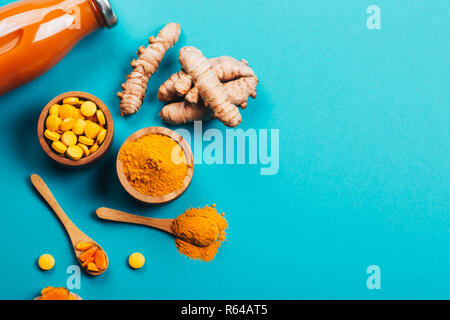 Verwirrung der Gelbwurz Werk in verschiedenen Bedingungen: frischen, trockenen Wurzel, Pillen, Pulver und schneiden Pflanze auf blauem Hintergrund. Flach Stil. Für Text platzieren. Stockfoto