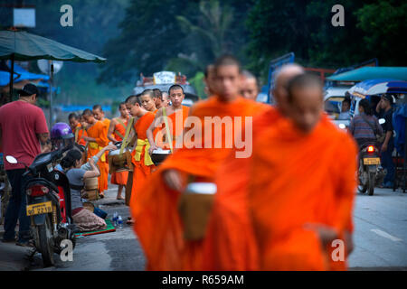 Tak Bat Ritual - Buddhistische Mönche erhalten Reis und Lebensmittel aus pupulation am frühen Morgen in Luang Prabang, Laos, Asien Stockfoto