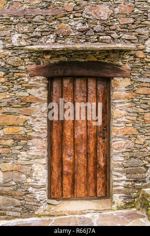 Rustikale hand behauenen Holz Tür in eine Mauer aus Stein, die in den Skandal, einer der Portugal schiefer Dörfer in den Aldeias do Xisto einstellen Stockfoto