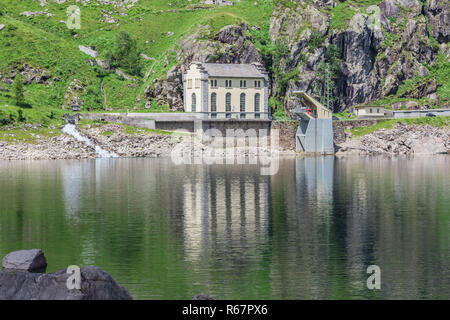 Campiccioli Damm, in Antrona Nationalpark, Piemont, Italien, zeigt das alte Wasserkraftwerk im Wasser spiegelt, Stockfoto