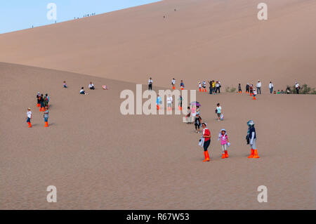 Dunhuang, China - August 8, 2012: Gruppe der chinesischen Touristen im Crescent Moon Lake in der Nähe von Dunhuang in der Provinz Gansu, China. Stockfoto