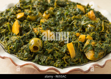 Schale mit marokkanischen Stil Spinatsalat mit grünen Oliven und erhaltene Zitrone Nahaufnahme Stockfoto