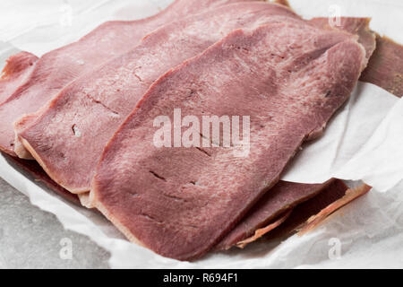 Geschnetzeltes Rindfleisch Zunge Schichten auf Papier. Bio geräuchertem Fleisch. Stockfoto