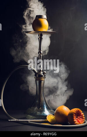 Shisha Kohlen auf Shisha Kopf mit schwarzem Hintergrund. Stilvolle orientalische Shisha. Grapefruit Stockfoto