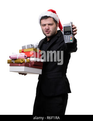 Bild von ernster Mann in santa hut mit Kartons mit Geschenken die Anschlußklemme in der Hände Stockfoto