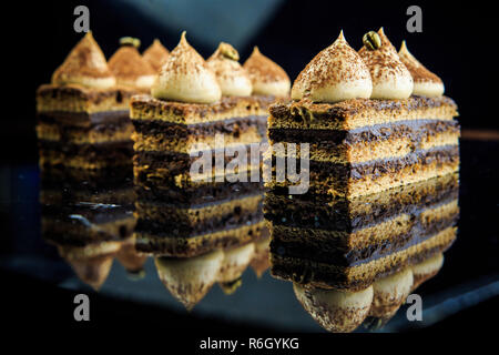 Oper cake Slices auf Black Mirror Hintergrund Stockfoto