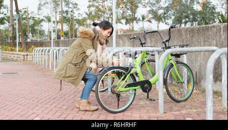 Die Frau mit dem Fahrrad in der Stadt Stockfoto