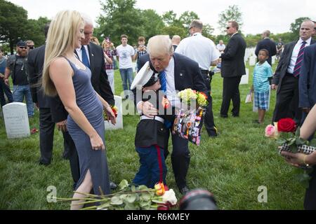 Präsident Donald J. Trumpf und Vice President Mike Pence Gespräch mit Christian Jacobs, 6, und seine Mutter Bretagne am Grab seines Vaters in Abschnitt 60 von Arlington National Cemetery, Arlington, Virginia, 29. Mai 2017. Christian besucht mit seiner Mutter, Bretagne, jedes Jahr für Memorial Day. Stockfoto