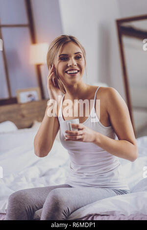 Schöne junge Frau breit lächelnd während Kaffee Stockfoto