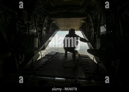 DARWIN, Australien - US Marine Sgt. Phil Berry, Waffen und Taktiken Instructor, Marine Medium Tiltrotor Squadron 268, Marine Drehkraft Darwin, sieht die Rückseite einer B MV-22 Osprey, wie sie ihren Weg bis zu einem Hubschrauber Support Team für einen externen Heben auszuwählen, 26. Mai 2017. Dies ist die Osprey ersten Entwicklung nach Australien und hat mit der Interoperabilität Schulungen für die Australian Defence Force und US-Marines hinzugefügt. Berry, 28 Jahre alt, ist von Annapolis, MD. Stockfoto
