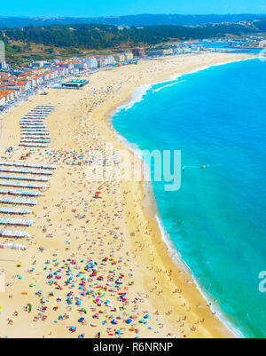 Menschen Sonnenbaden am Ocean Beach in einem Sommertag. Nazare, Portugal Stockfoto