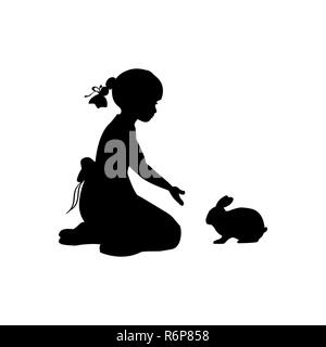 Silhouette Mädchen sitzen, knien winken Kaninchen Stockfoto